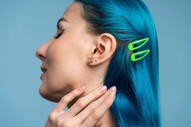 How can I avoid complications from ear piercings